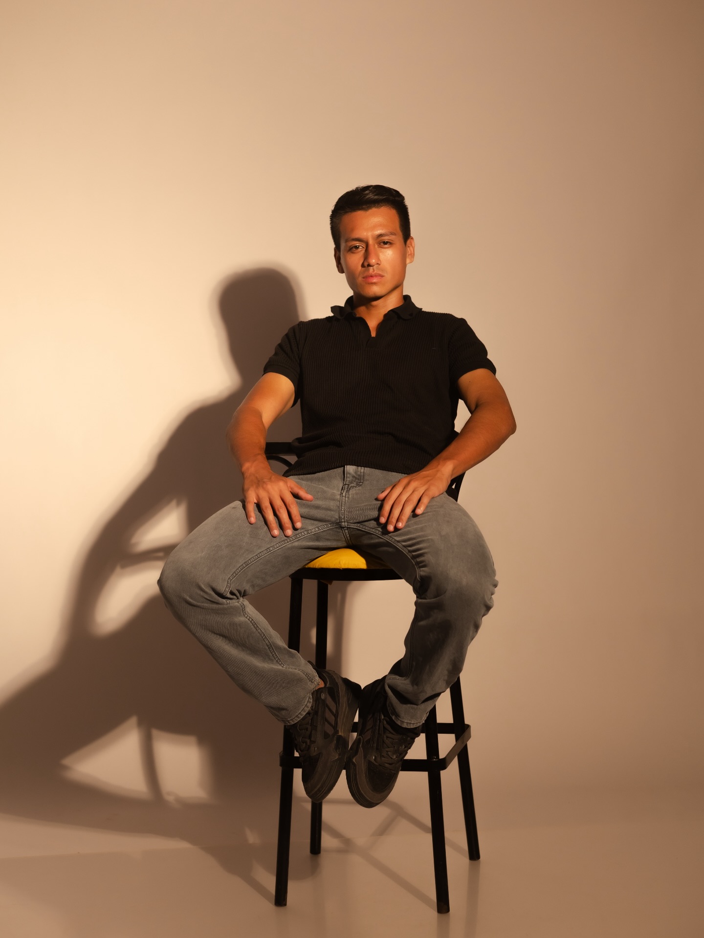 Joaquín OS, fotógrafo y creador audiovisual, sentado en un estudio con luz cálida